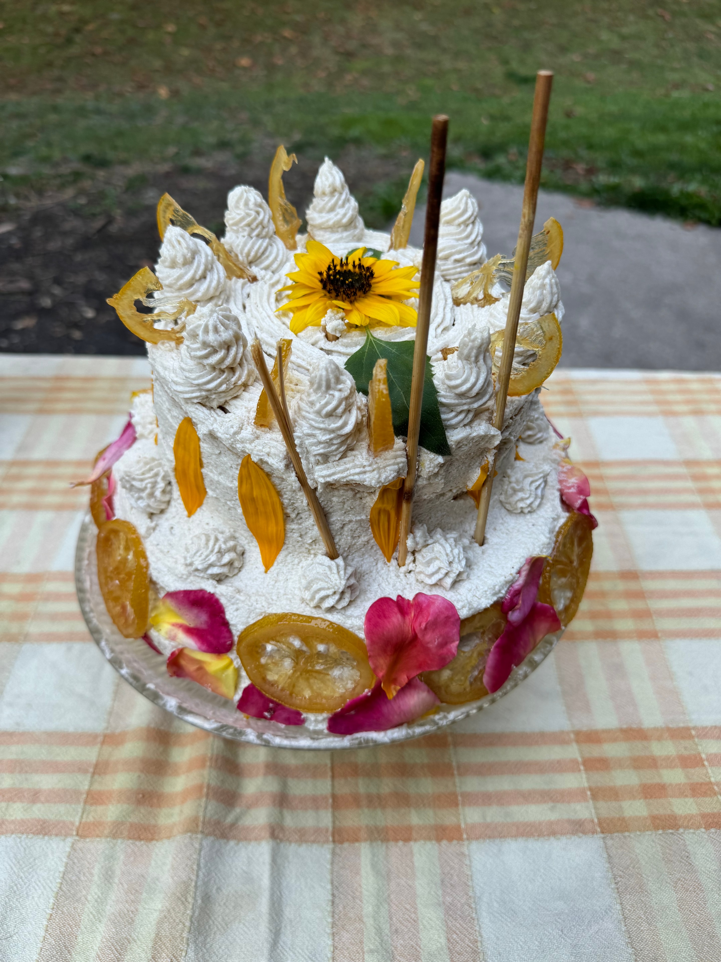 Beautifully decorated cake with flowers and dried citrus